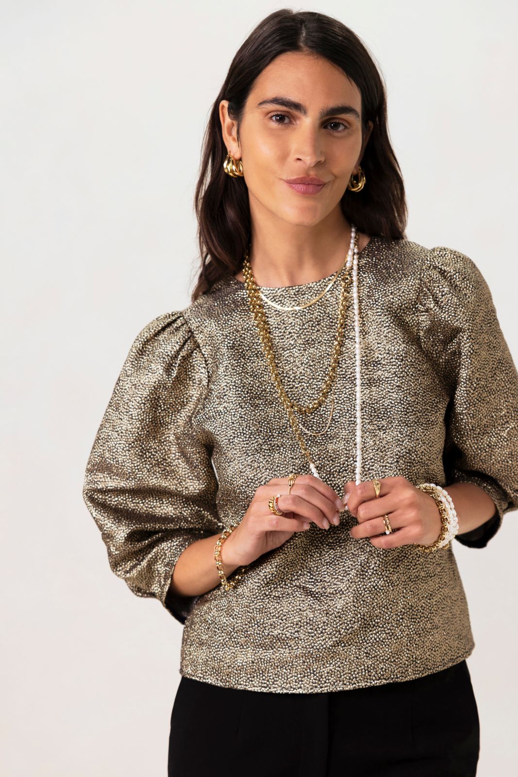 Gouden metallic top met strikdetails