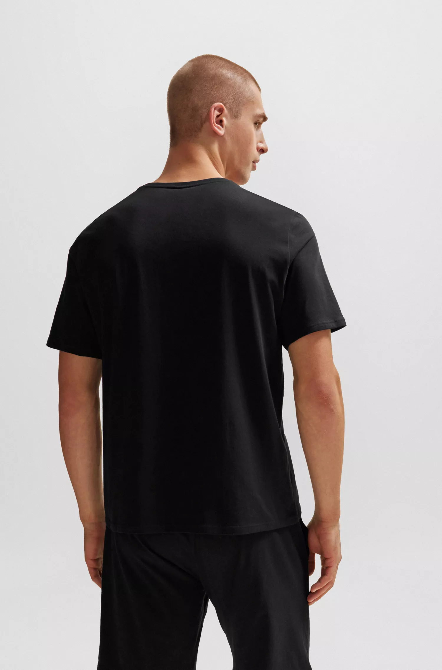 Camiseta de pijama BOSS preta em algodão stretch com listra e logotipo característicos.