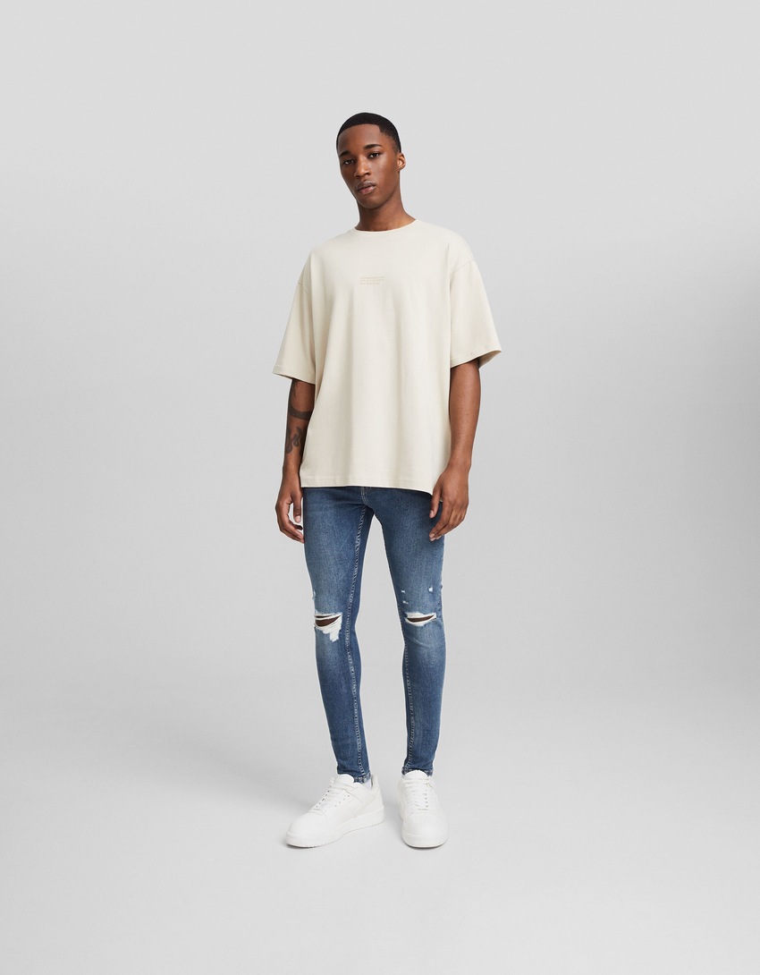 Calça jeans skinny rasgada