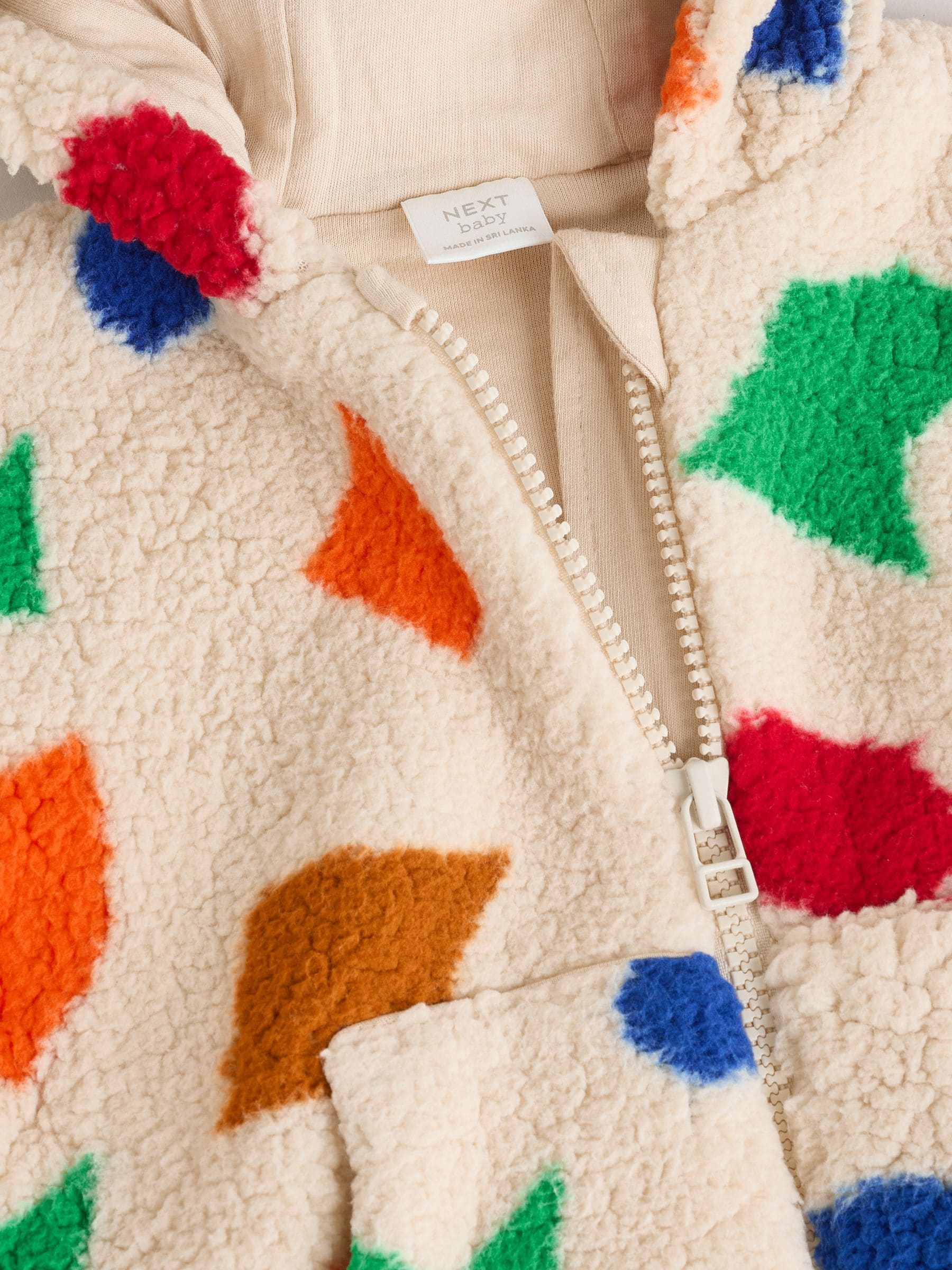 Natuurlijk felgekleurd met geometrische print - Babyjack met rits en capuchon (0mnd-2jr)