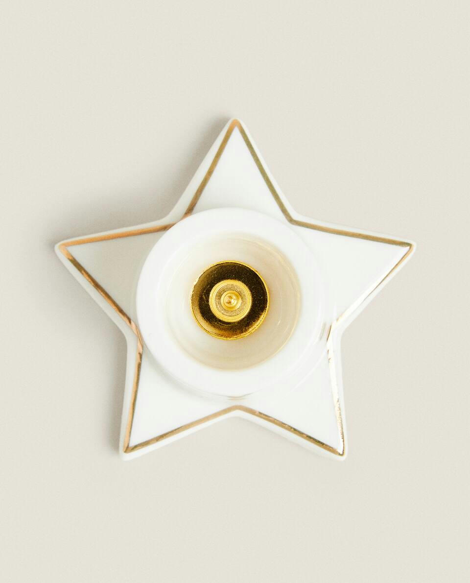 Castiçal pequeno em formato de estrela de Natal com borda