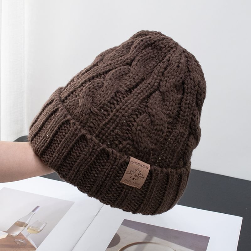 Raconteur - Gebreide muts met appliqué