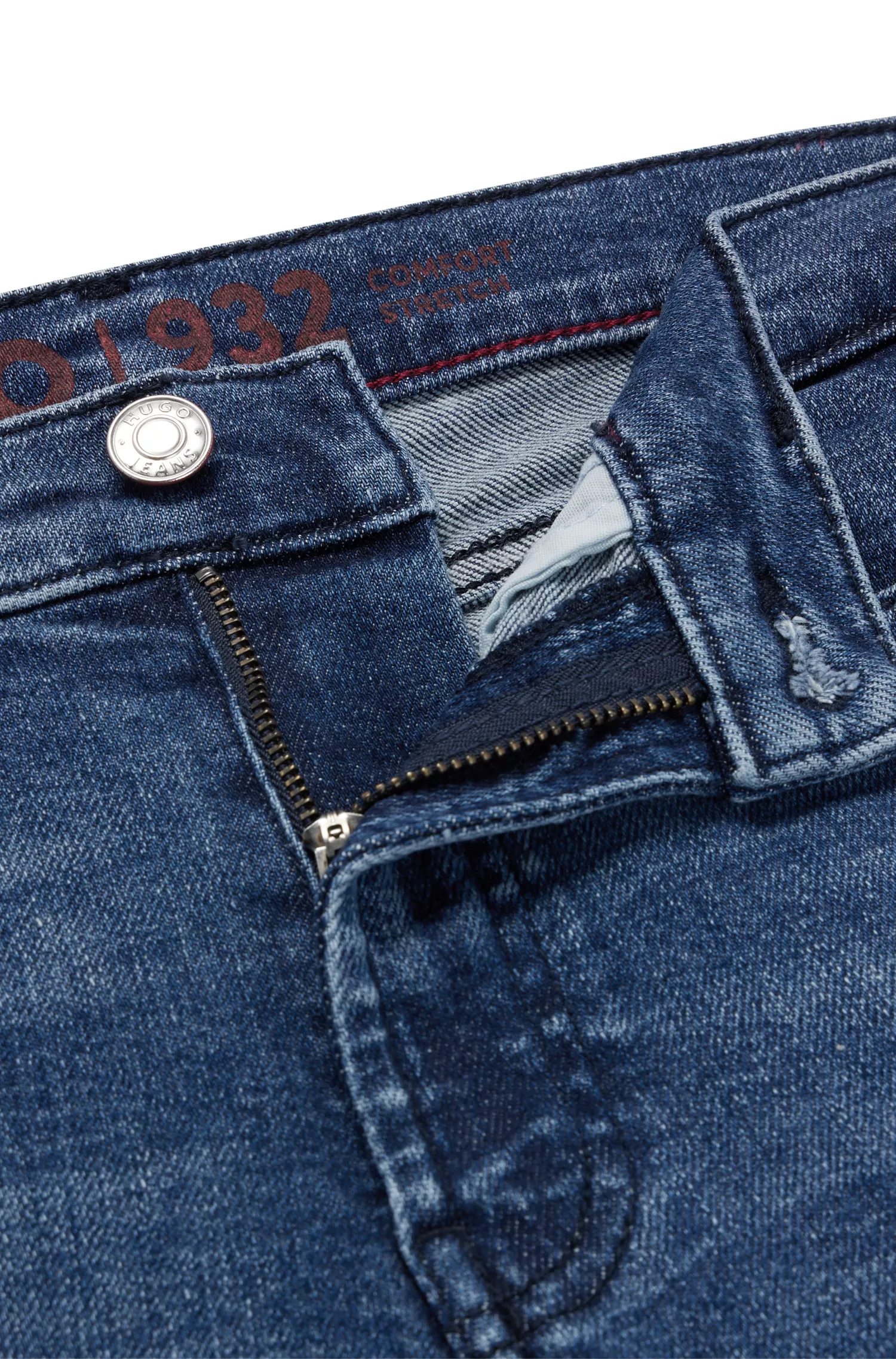 Calça jeans HUGO vermelha, extra slim fit, em denim super elástico azul.