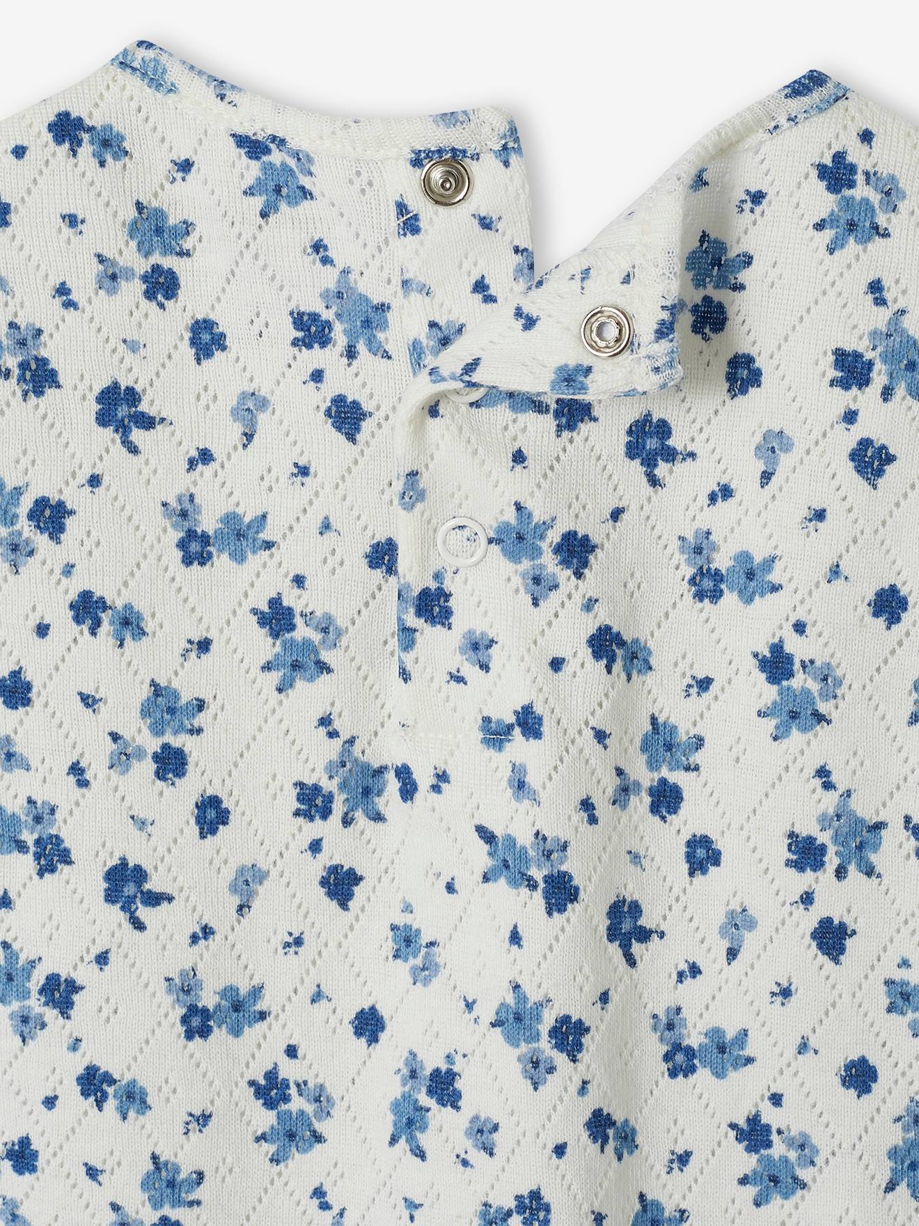Camiseta infantil de malha aberta com estampa floral.