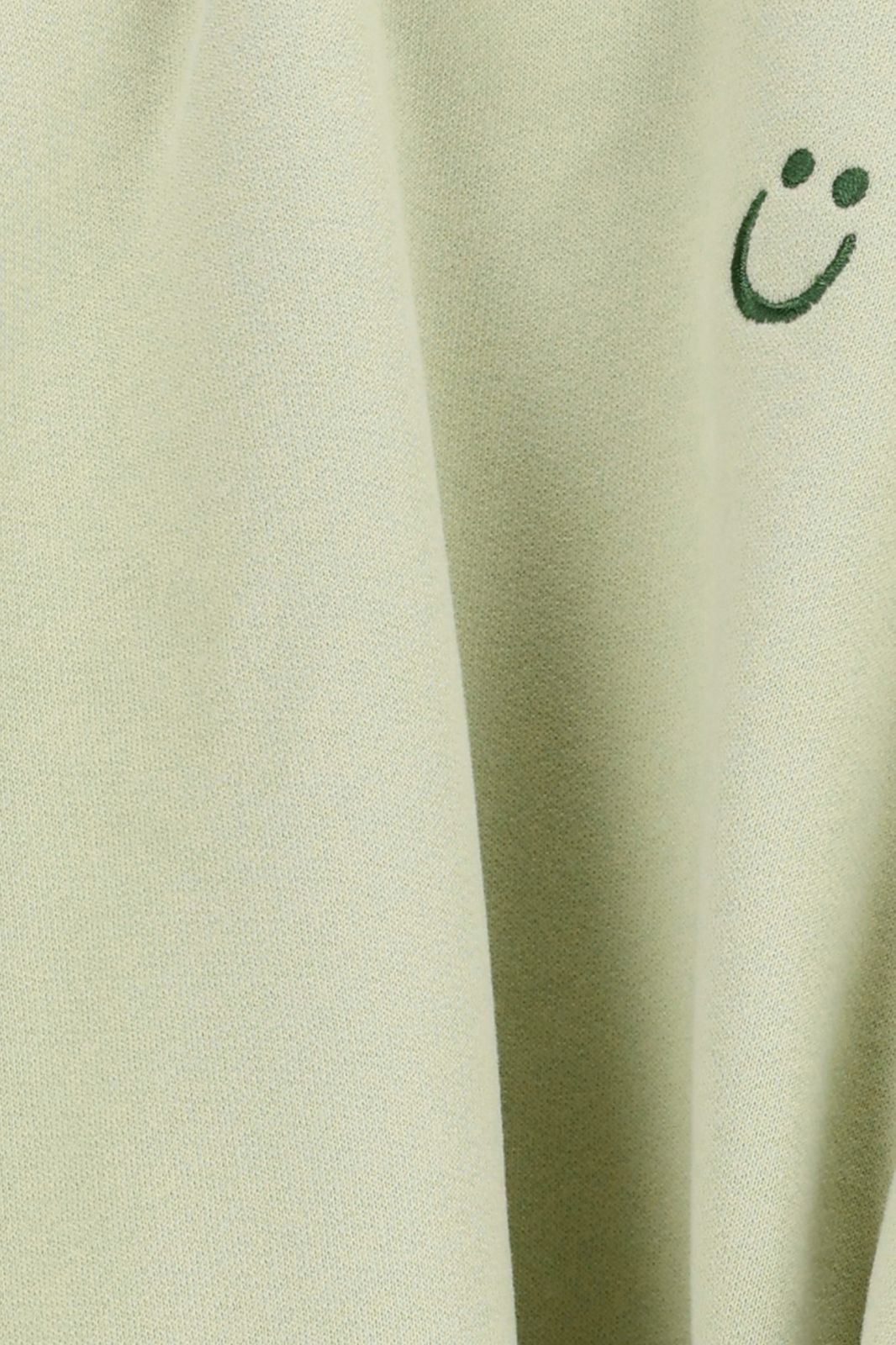 Lichtgroene oversized sweater met ruffles en smiley patch