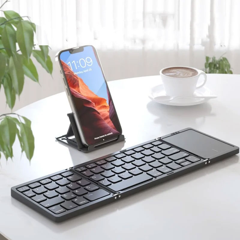 Faltbare Mini Bluetooth Tastatur mit Touchpad für Macbook / Laptop / Tablet / Smartphone inkl. Handy-Halterung (iOS / Android) - Schwarz