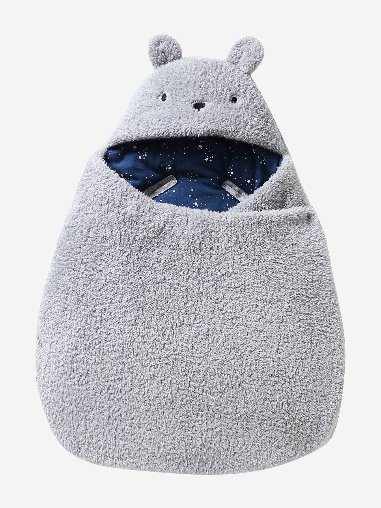 Saco transformável em brinquedo de pelúcia. Urso de pelúcia liso bege claro com estampas.