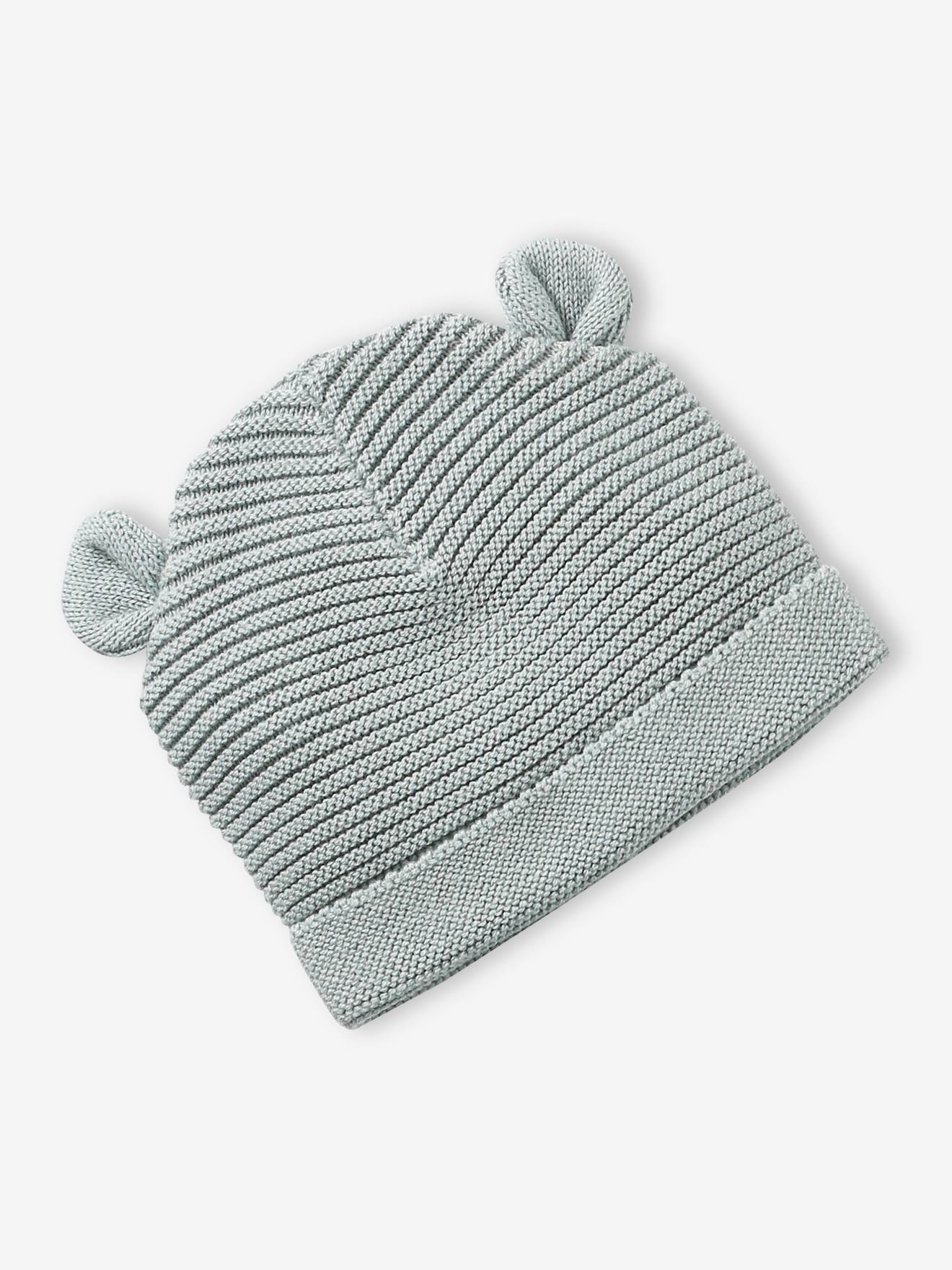Conjunto para recém-nascido com gorro, luvas e sapatinhos, acompanhado de bolsa azul-marinho combinando.