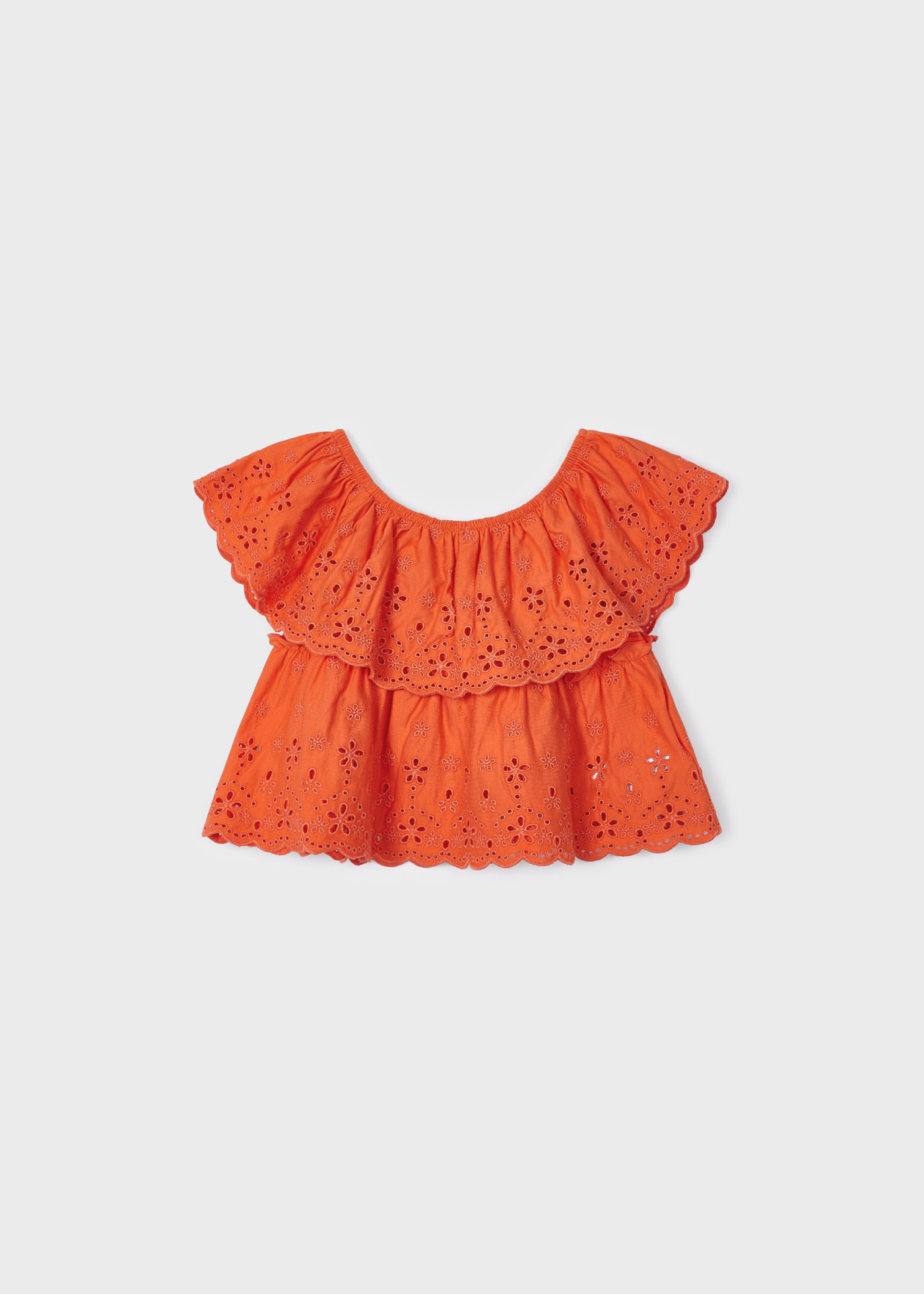 Blusa com motivos perfurados, feita de algodão sustentável, para meninas.