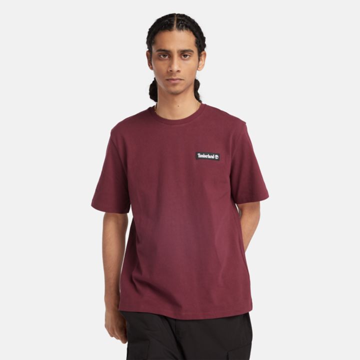 Camiseta unissex de tecido pesado com emblema na cor bordô.