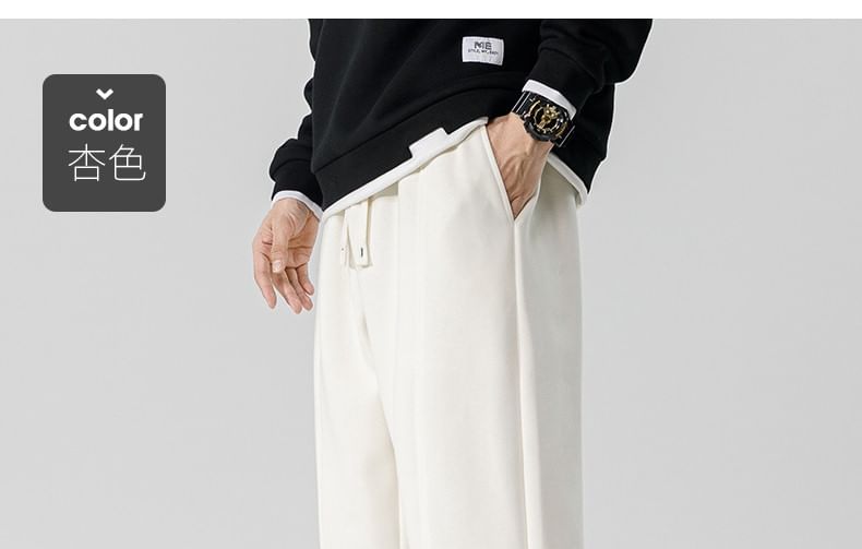 Dandyluxe - Cropped harem-joggingbroek met trekkoord en geborduurde letters
