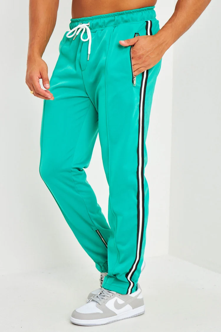 Pantalon de jogging vert satiné à bandes et zips