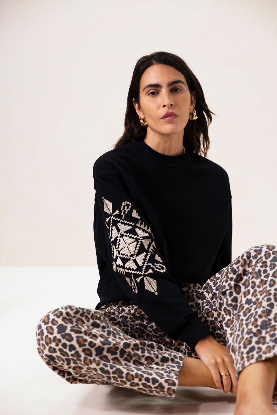 Zwarte sweater met geborduurde mouw
