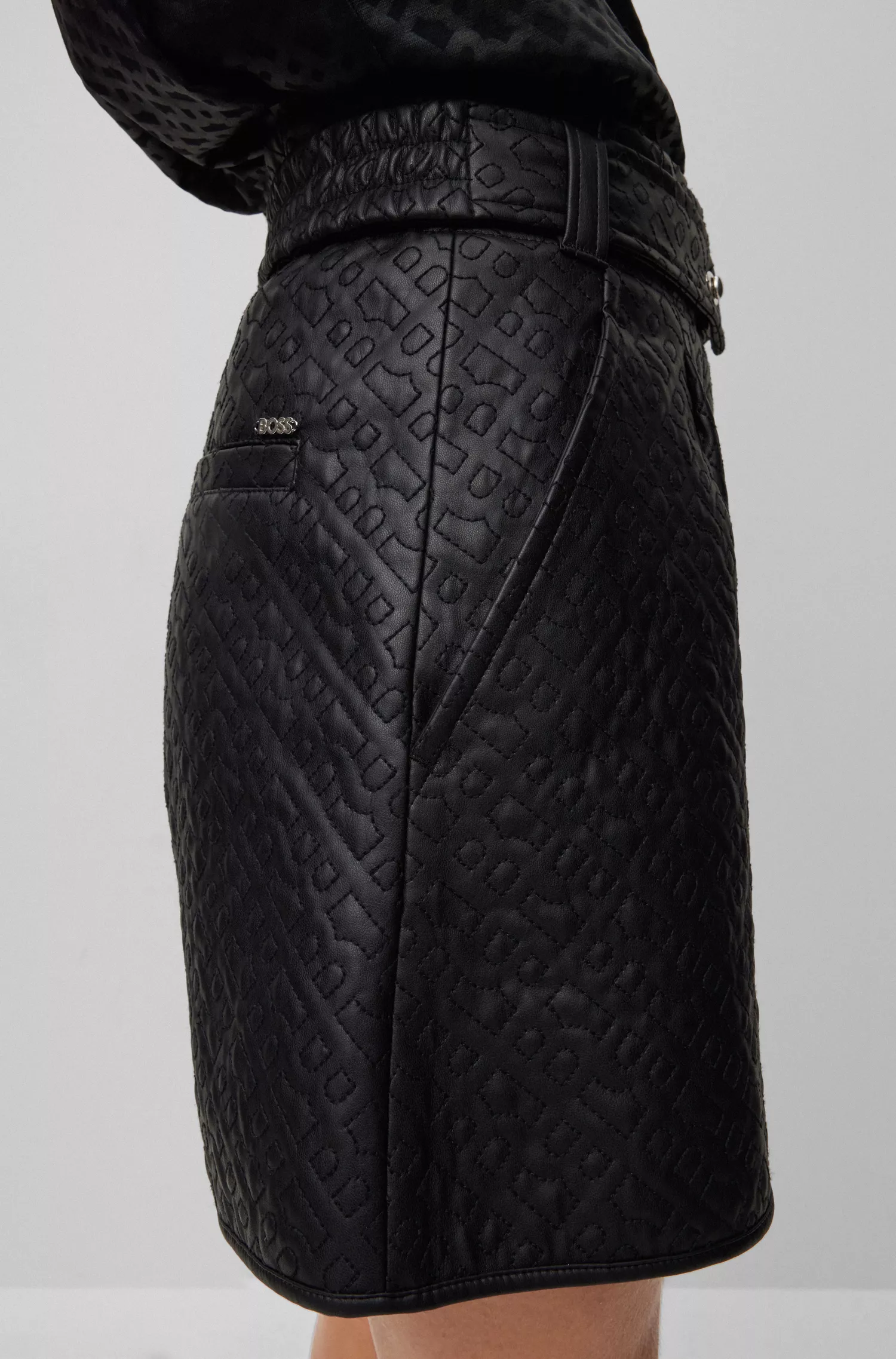 Shorts BOSS pretos de corte relaxado em couro sintético com monograma em relevo.