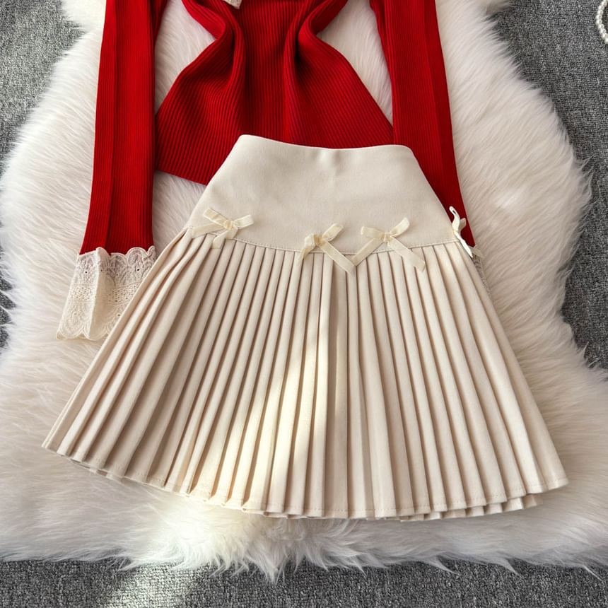 Yearnin - Set: lange mouwen, effen gebreide top met lintaccent + hoge taille mini-plooirok
