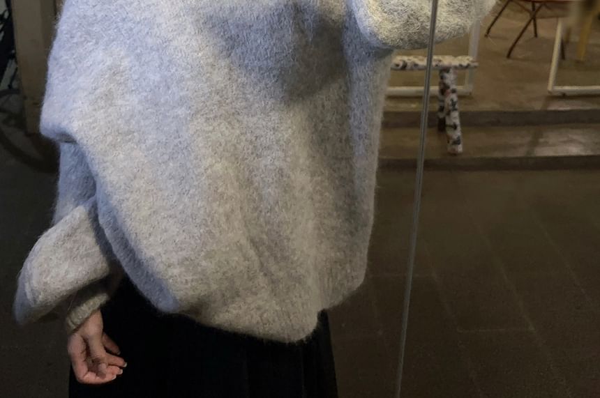 Magma - Oversized trui met pofmouwen, open rug en strik