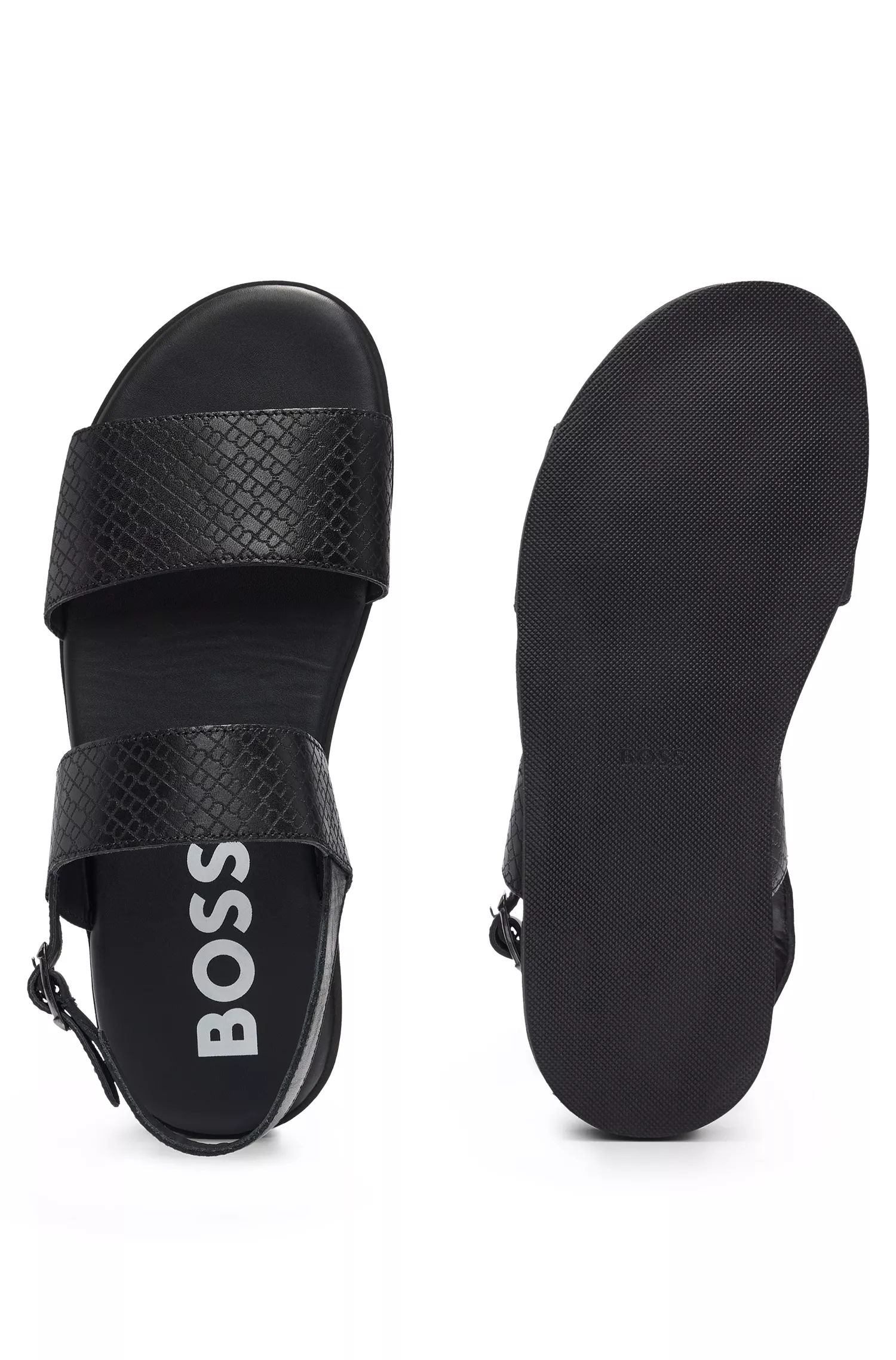 Sandálias BOSS em couro preto com logotipo em relevo e fecho de fivela.