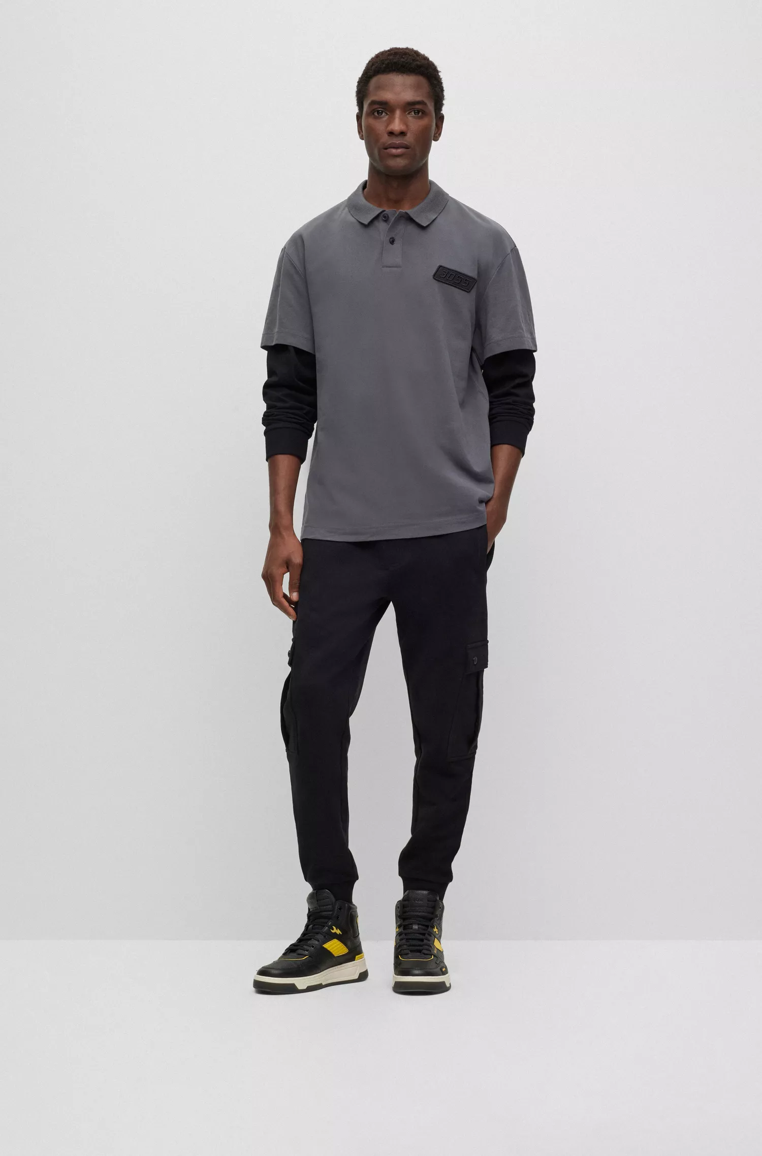 Camisa polo BOSS laranja, modelagem relaxada em piqué de algodão com mangas duplas.