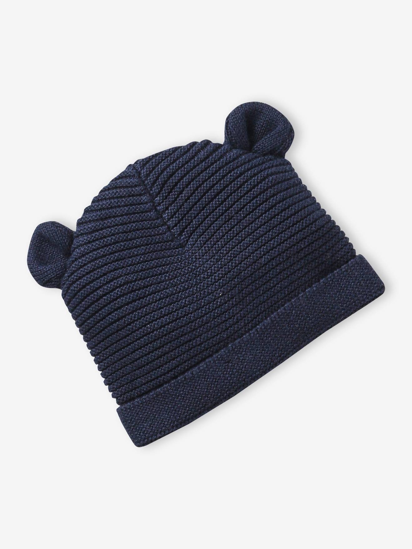 Conjunto para recém-nascido com gorro, luvas e sapatinhos, acompanhado de bolsa azul-marinho combinando.