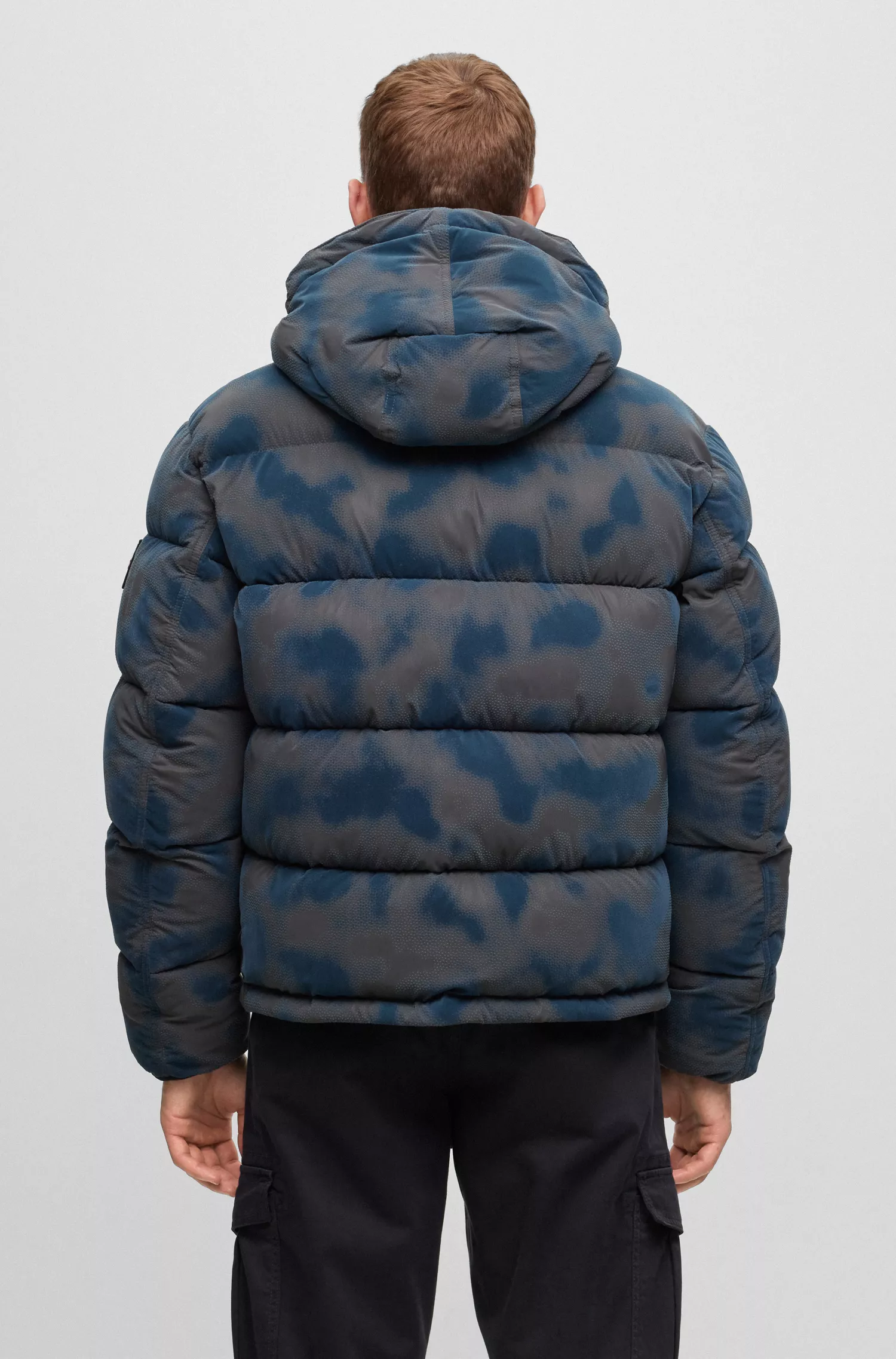 Jaqueta puffer BOSS laranja, modelagem relaxada e estampa flocada da estação.