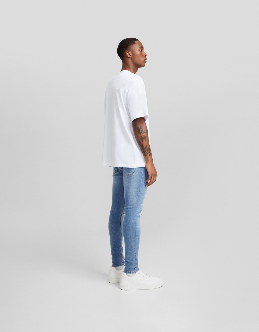 Calça jeans skinny rasgada