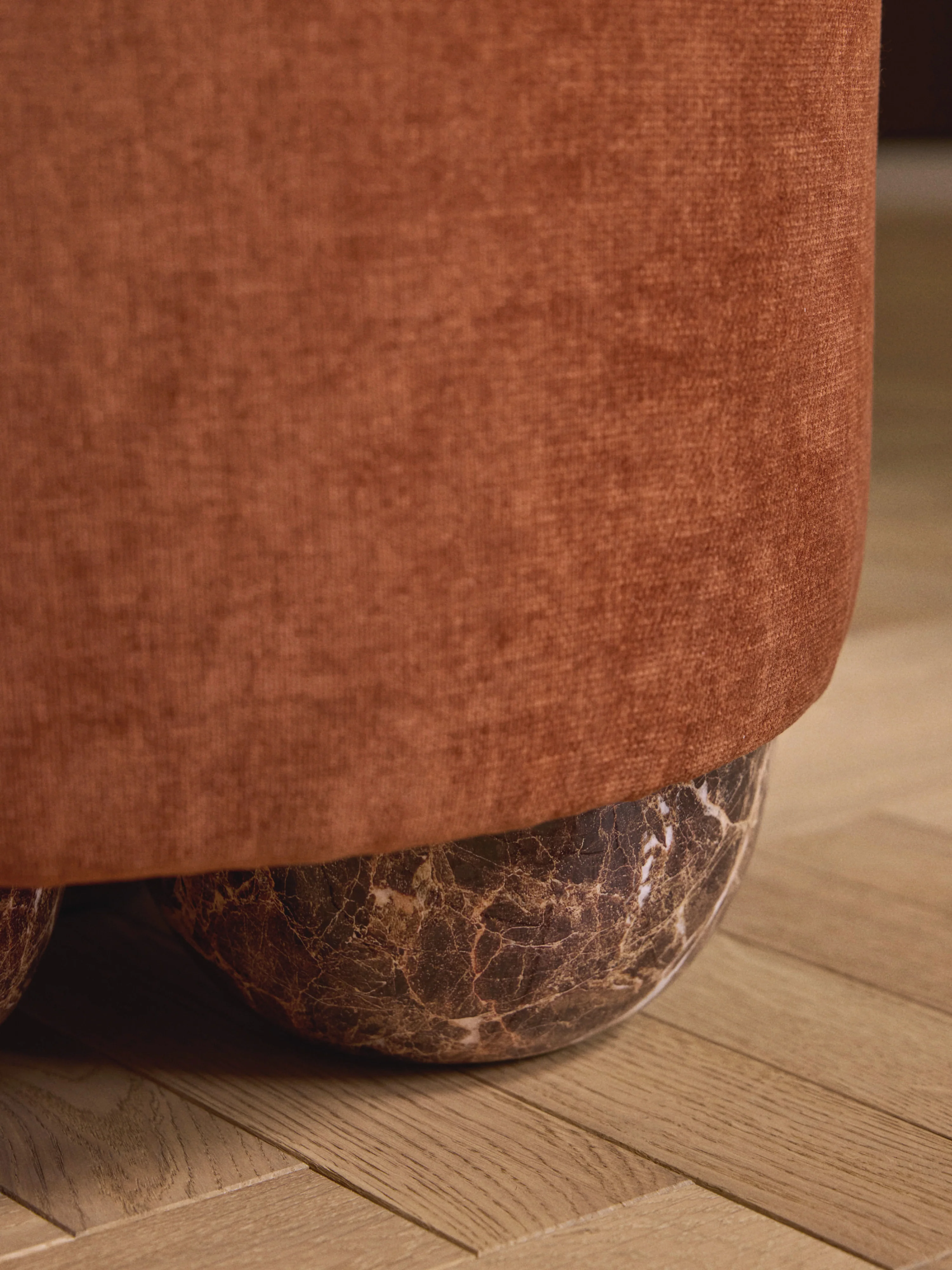 Beklede poef Lino met bolpoten met marmerlook