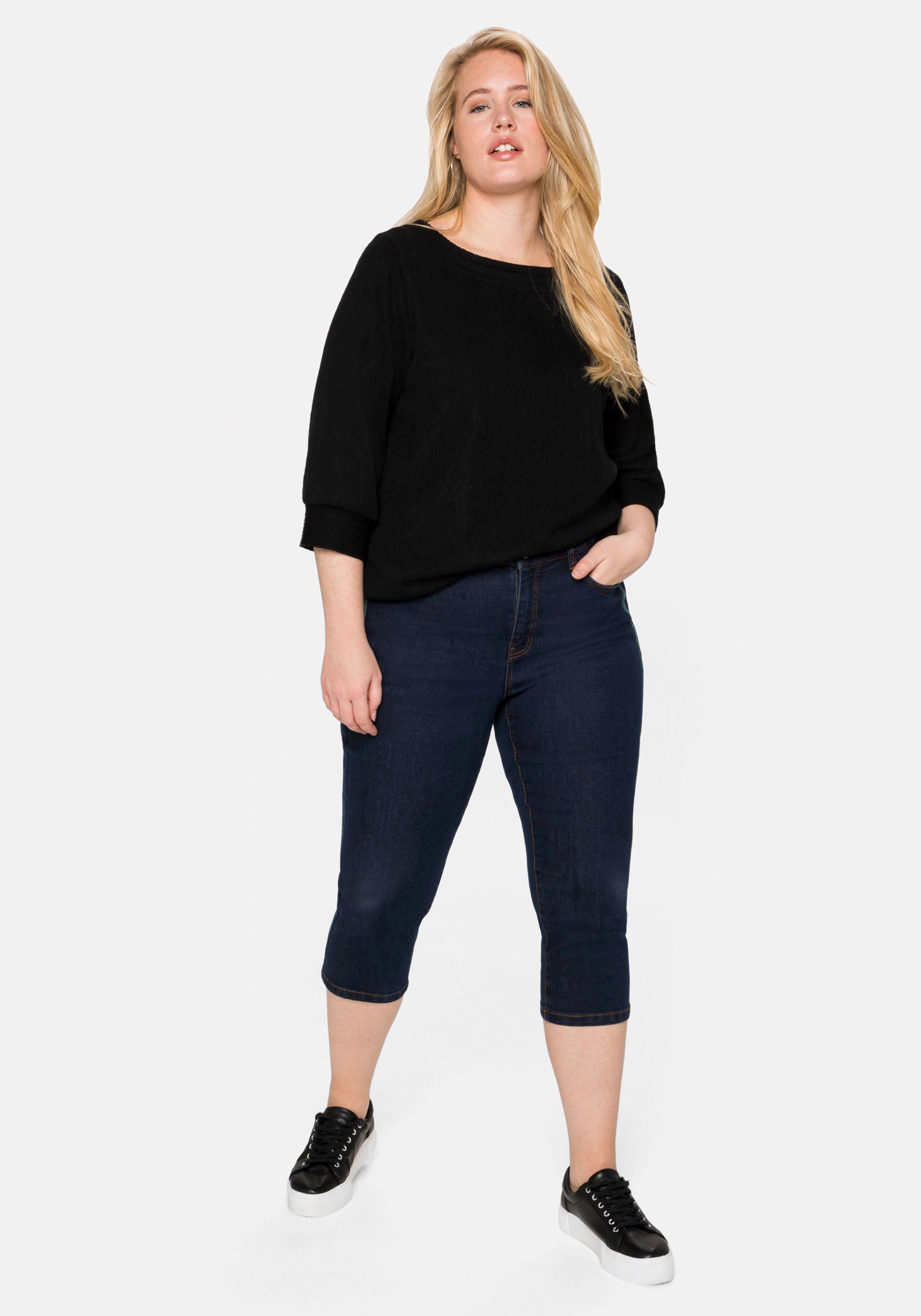 Caprijeans mit Catfaces und Kontrastnähten