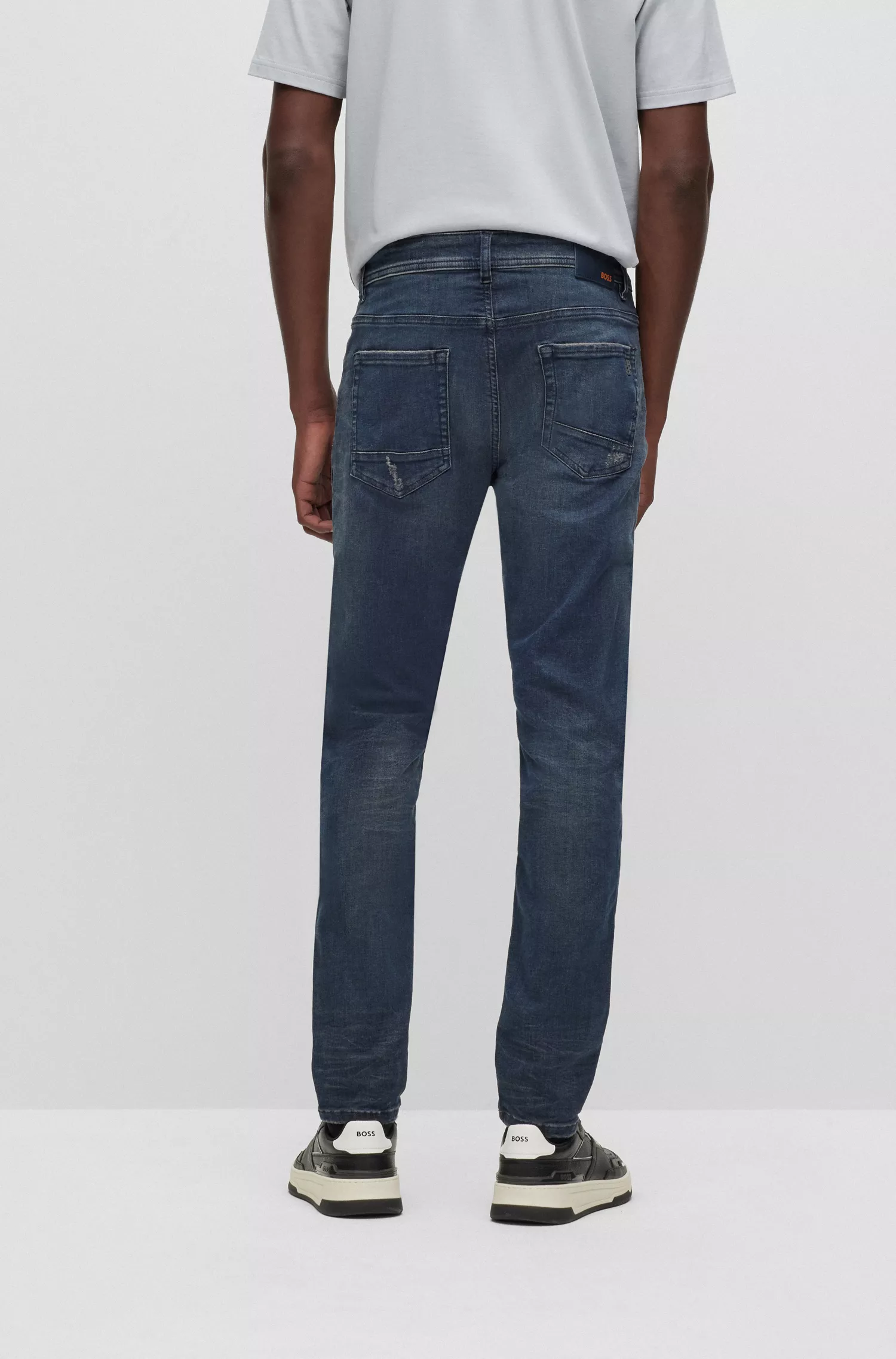 Calça jeans BOSS laranja com corte afunilado em denim superelástico com tonalidade cinza.