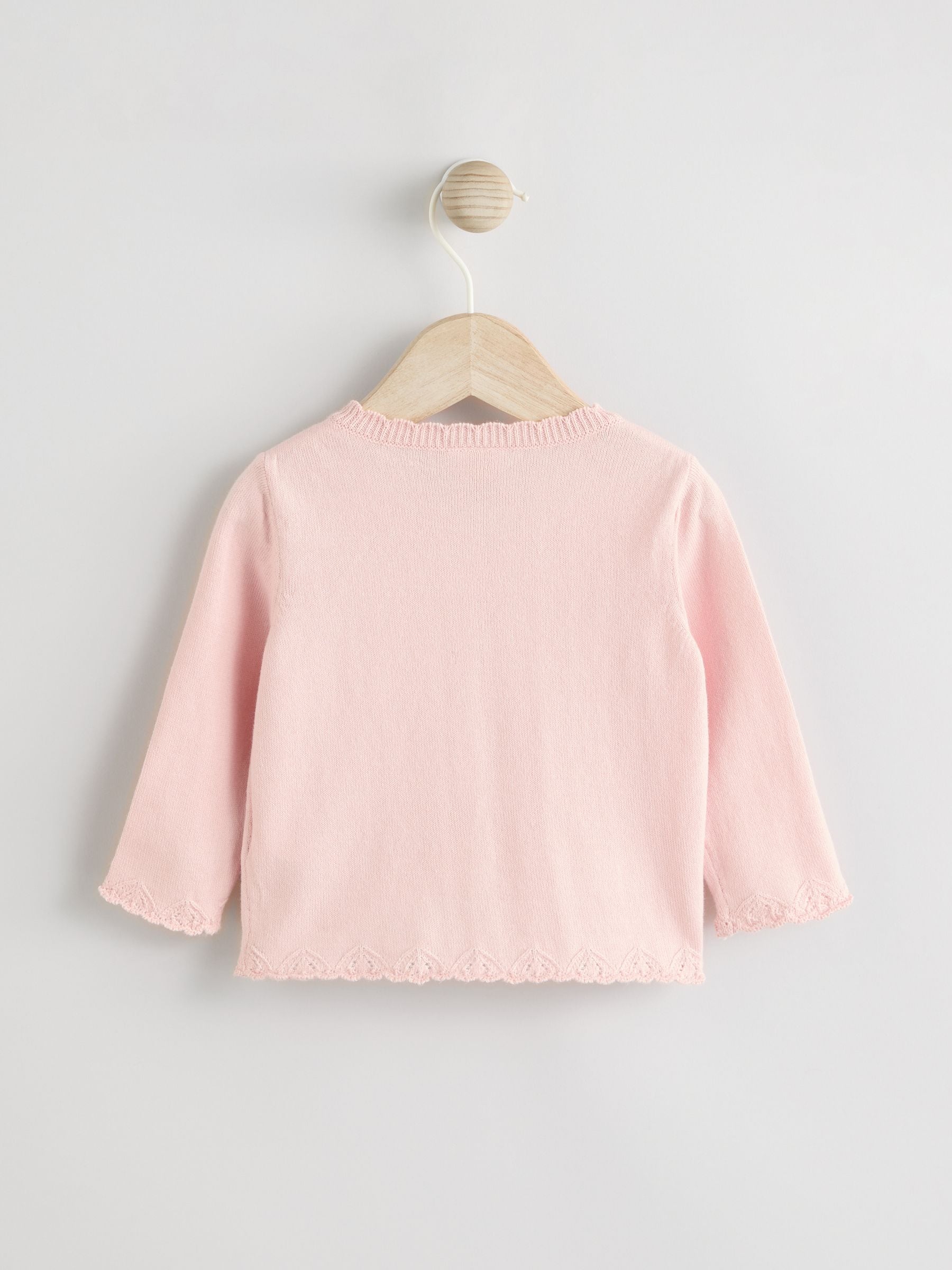 Roze vlinderborduursel - Gebreid babyvest (0 mnd- 2 jr)
