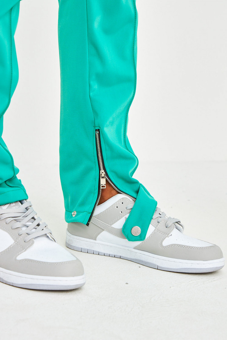 Pantalon de jogging vert satiné à bandes et zips