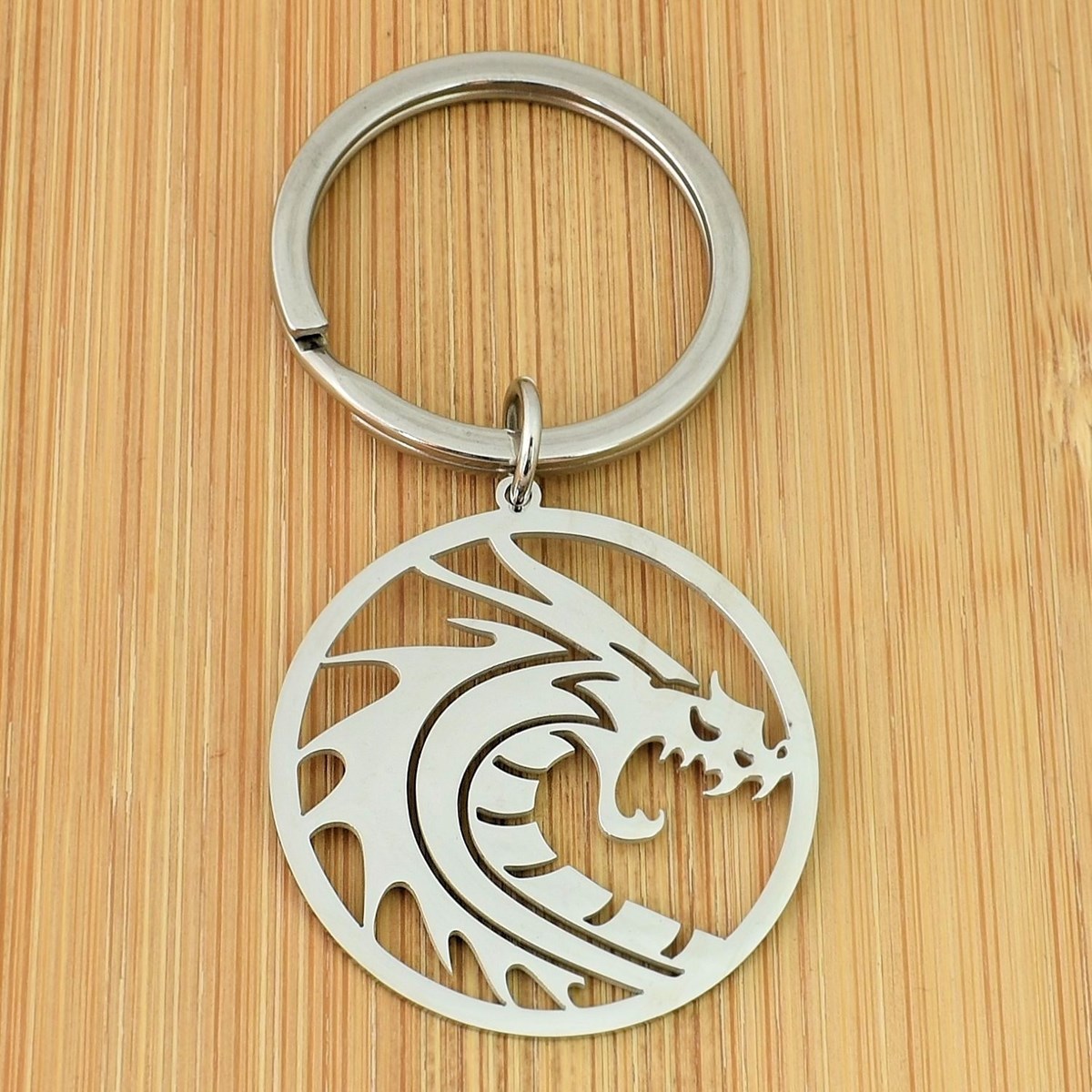 Porte-clés dragon dans un cercle acier inoxydable