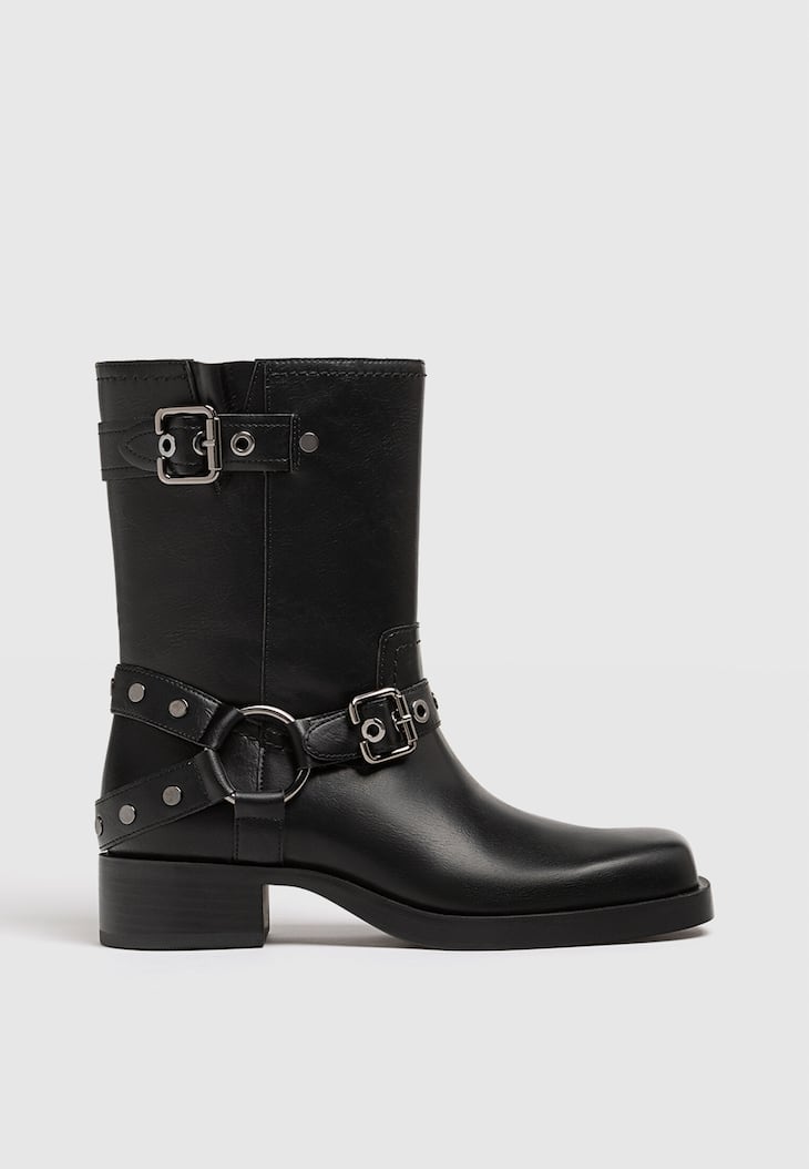 Botas de cano curto estilo motociclista, sem salto, com detalhes de fivela.