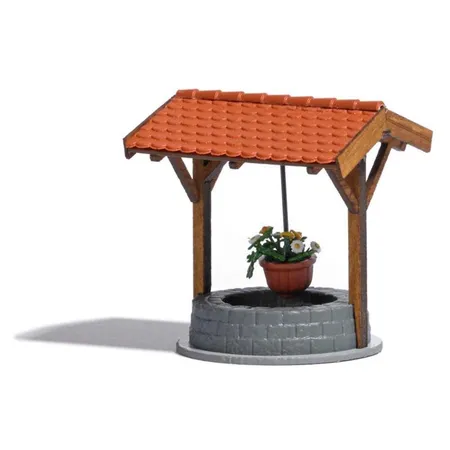 Busch Brunnen mit Blumenampel