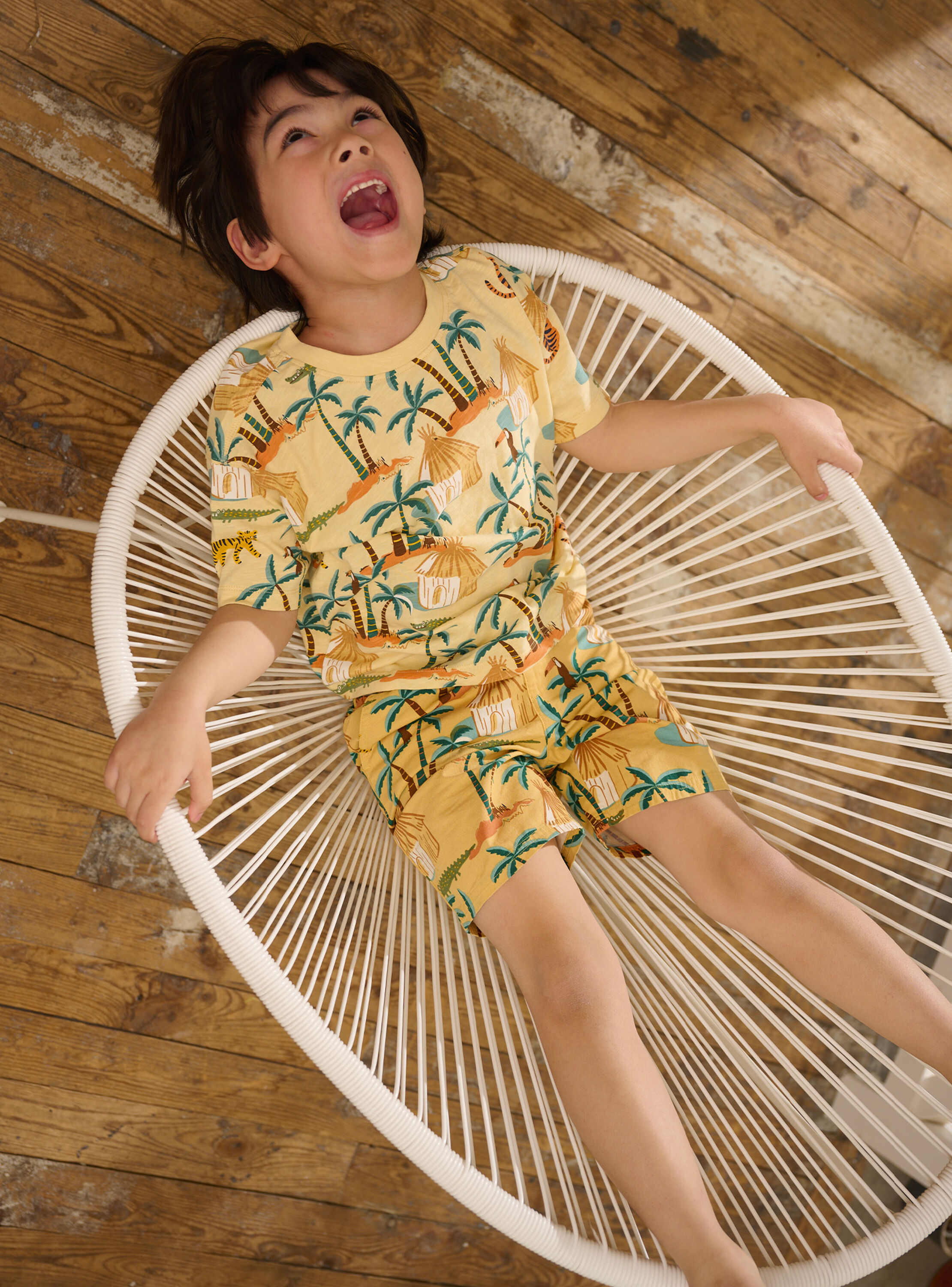 Boy's pale yellow Bermuda shorts with savannah print