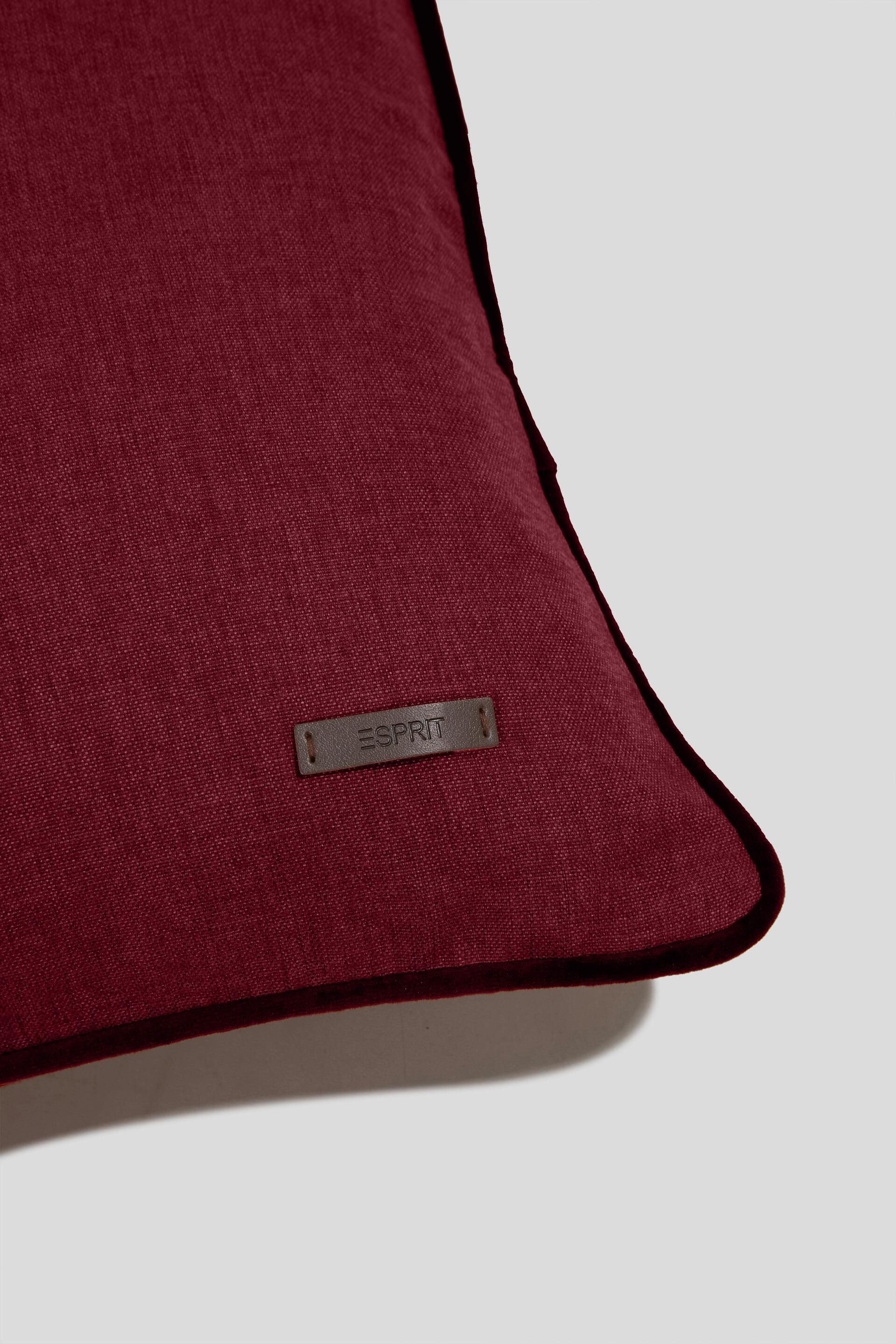 Housse de coussin décorative rehaussée d’un passepoil en velours