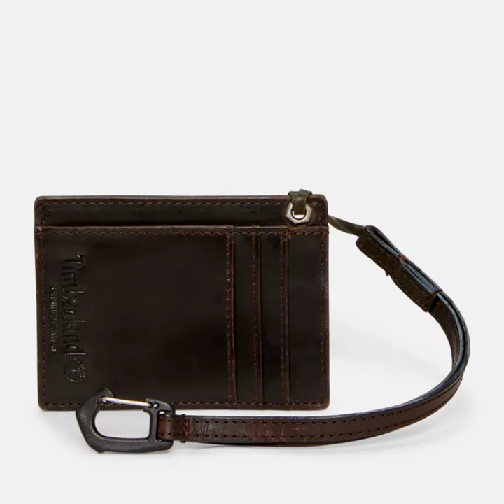 Porta-cartões de couro com cordão para homem, na cor marrom escuro.