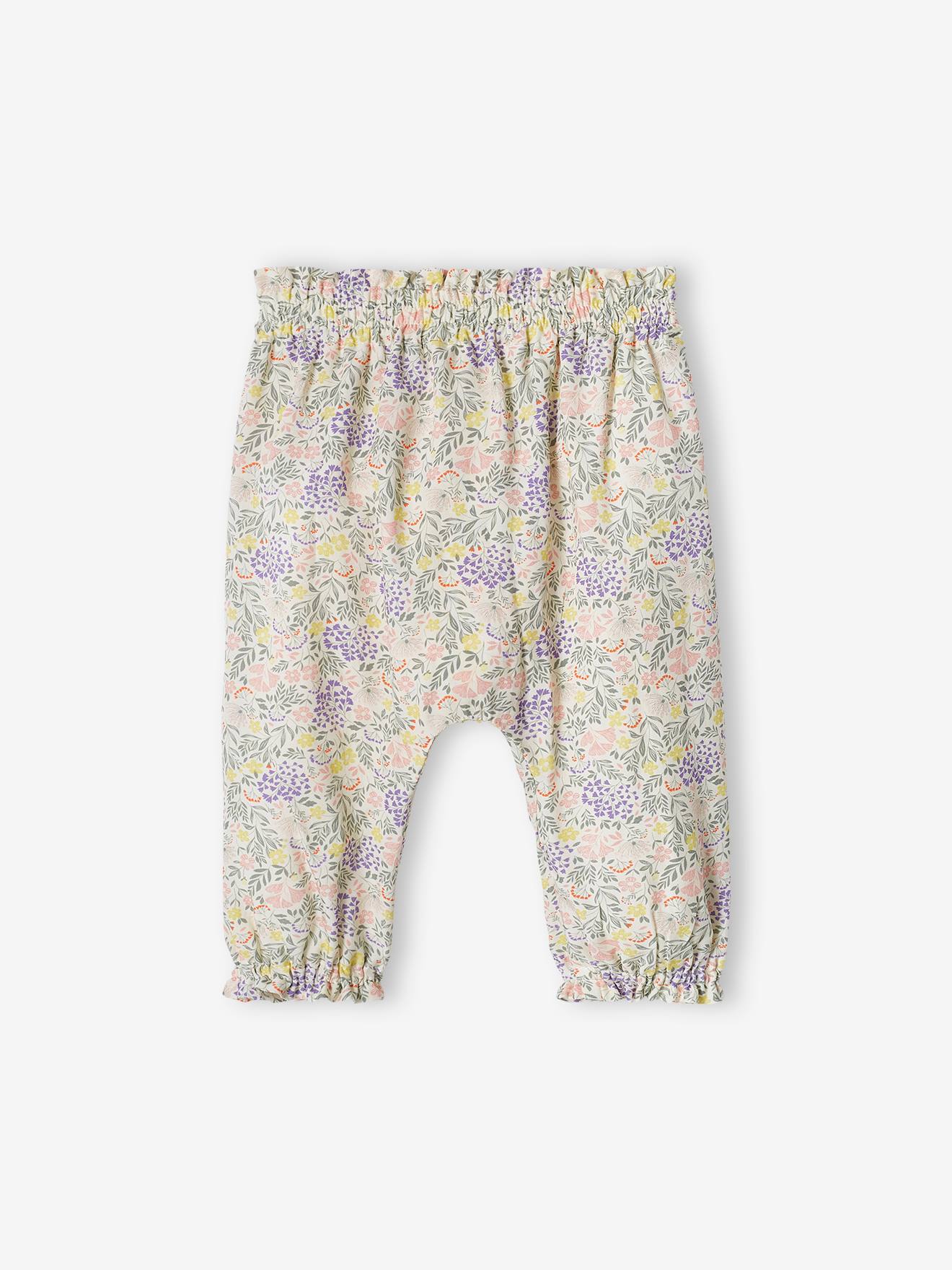 Calças fluidas estampadas para bebês na cor cru.