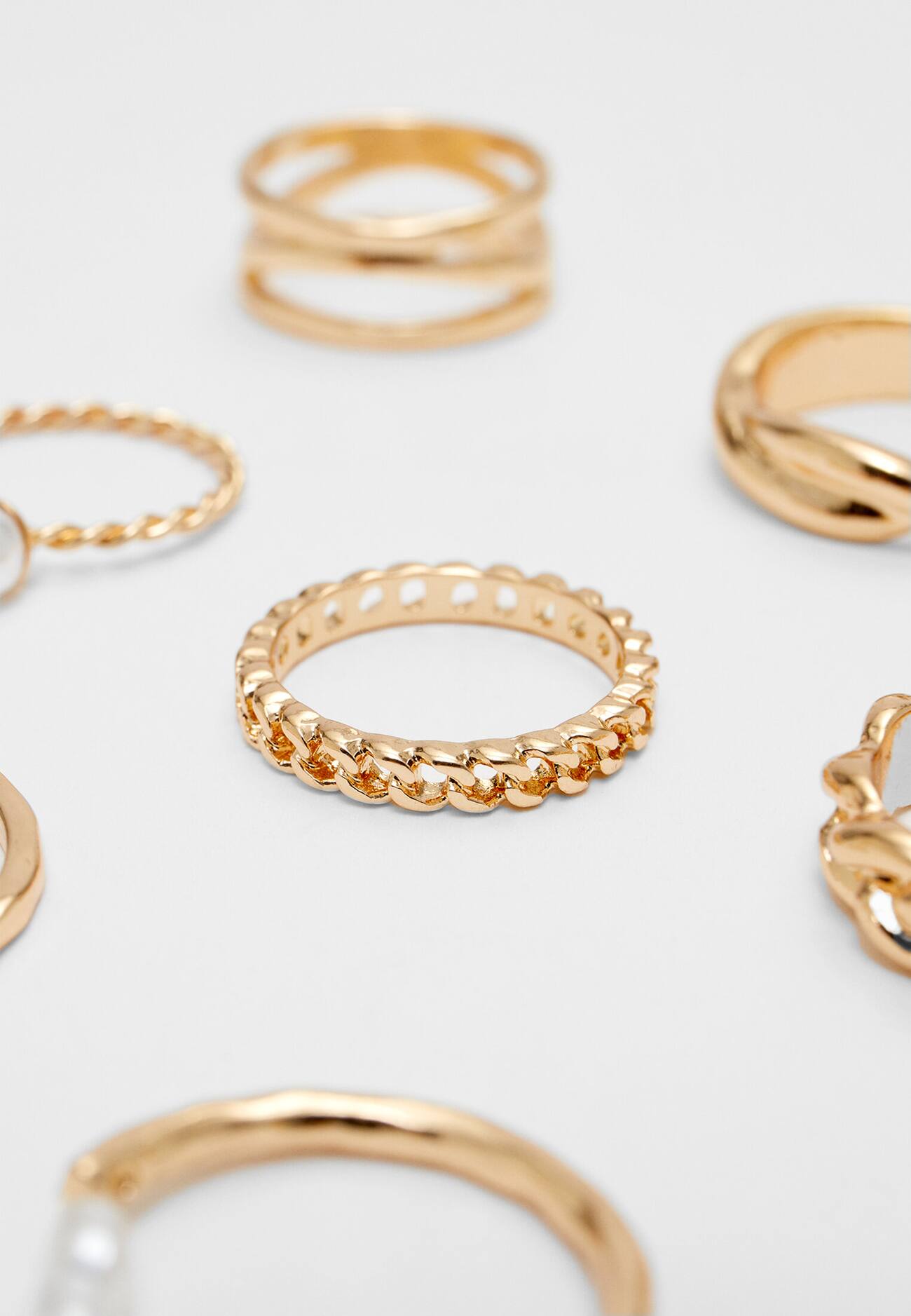 Conjunto de 7 anéis com strass e imitação de pérola.