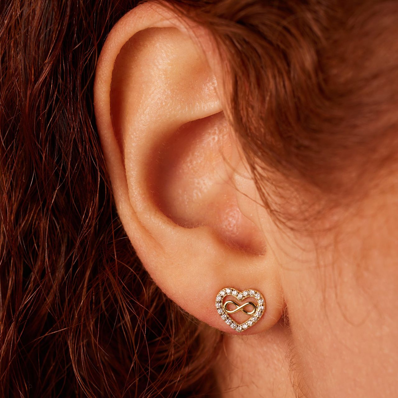 Zilveren goldplated oorknoppen hart infinity zirkonia
