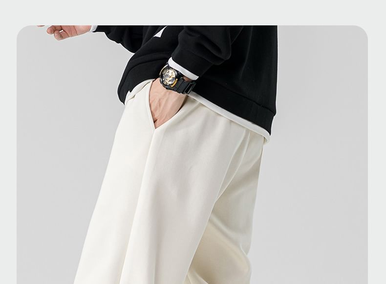Dandyluxe - Cropped harem-joggingbroek met trekkoord en geborduurde letters
