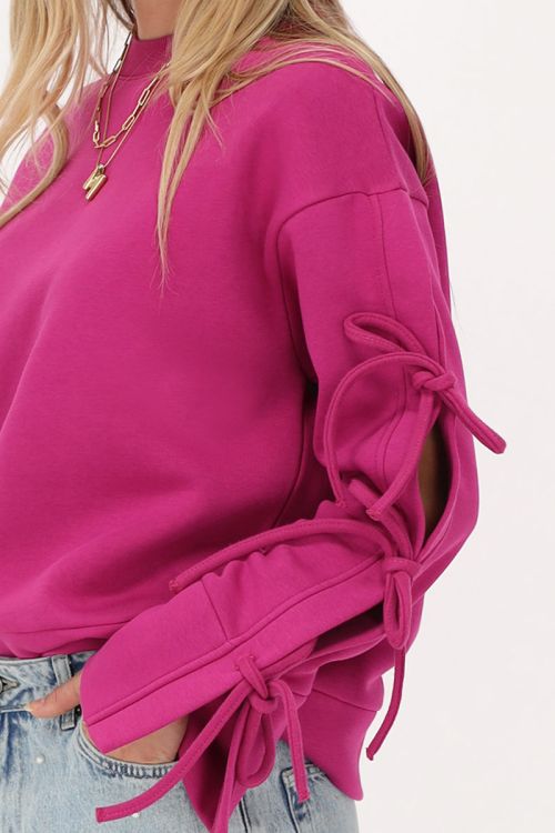 Fuchsia sweater met strikjes