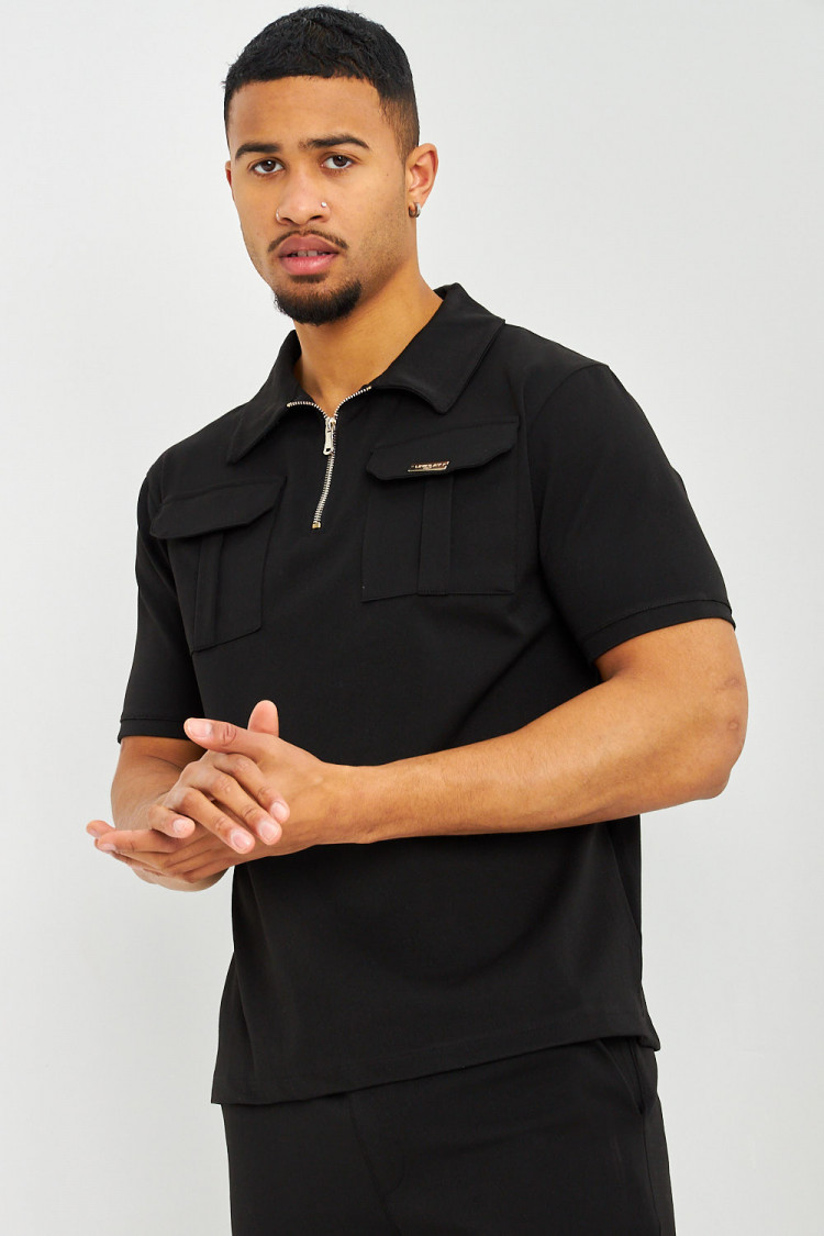 Polo uni noir col zippé à poches