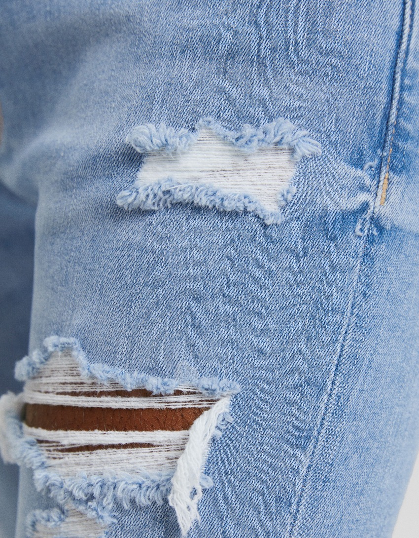 calça jeans super skinny rasgada
