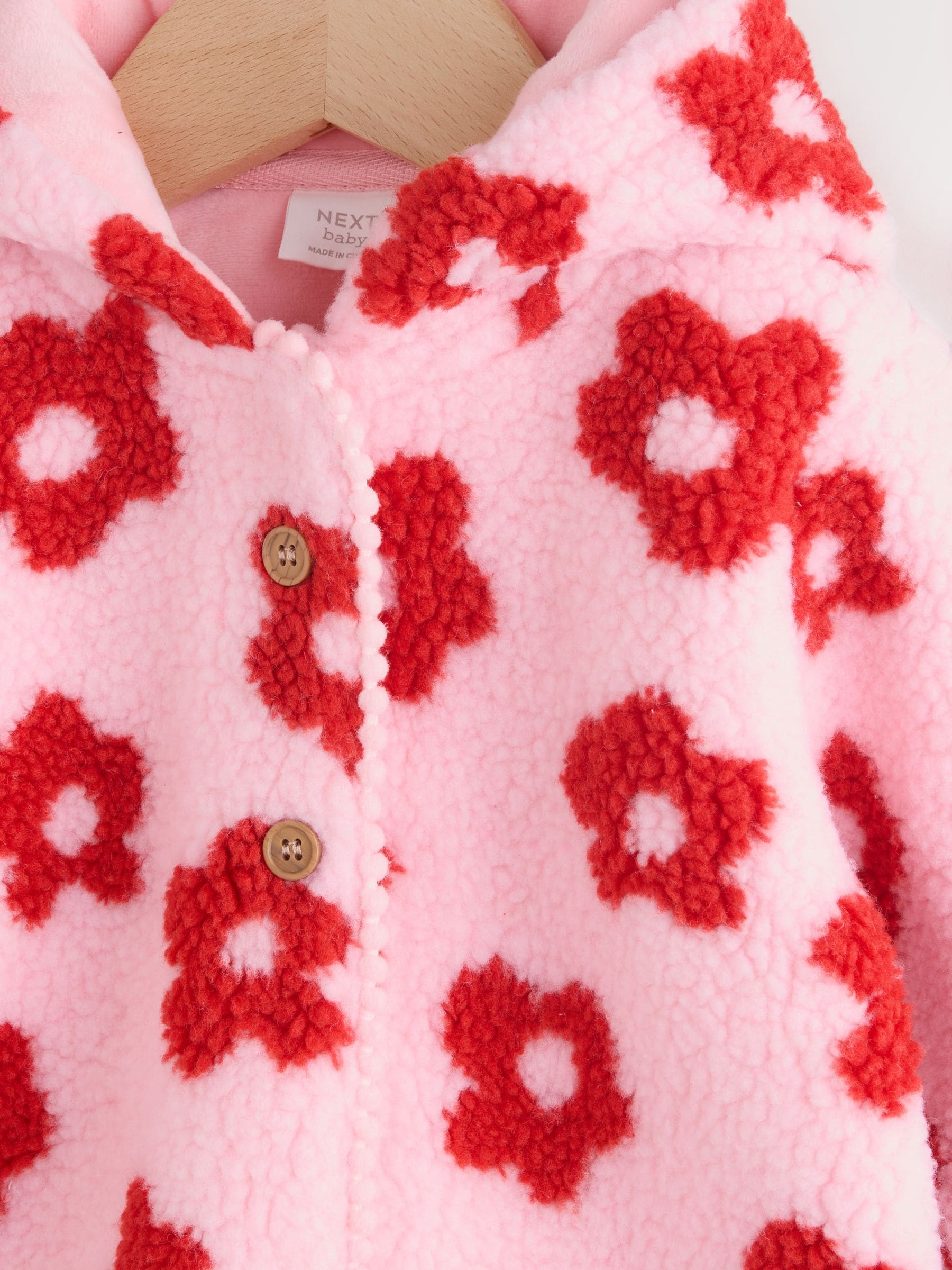 Roze bloemenprint over het geheel - Borg babyjack met capuchon (0mnd-2jr)