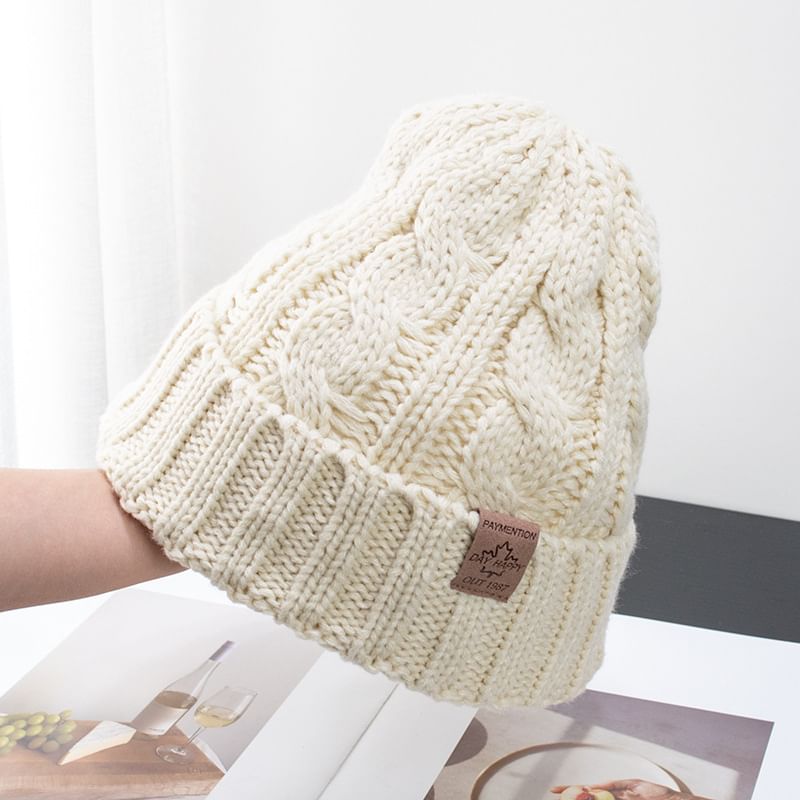 Raconteur - Gebreide muts met appliqué
