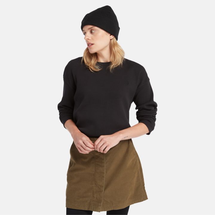 Camiseta feminina de manga comprida com textura waffle na cor preta.