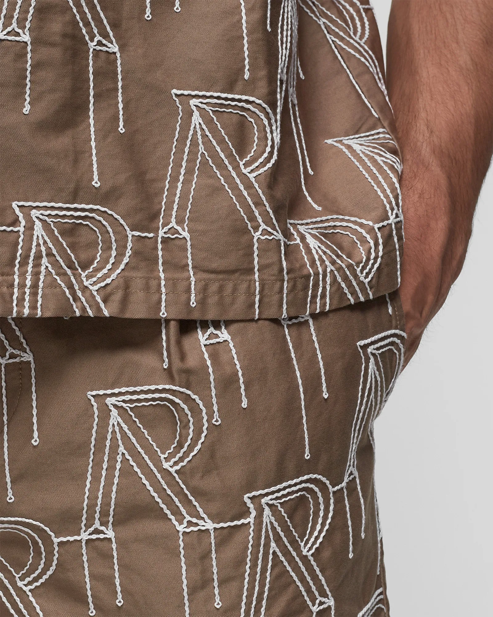Represent EMBRODIERED INITIAL TAILORED SHORT