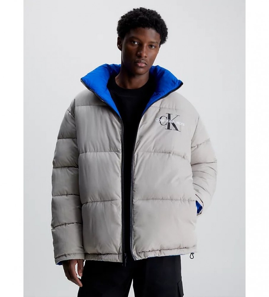 Jaqueta reversível de plumas Calvin Klein Jeans, azul e cinza, estilo anos 90.