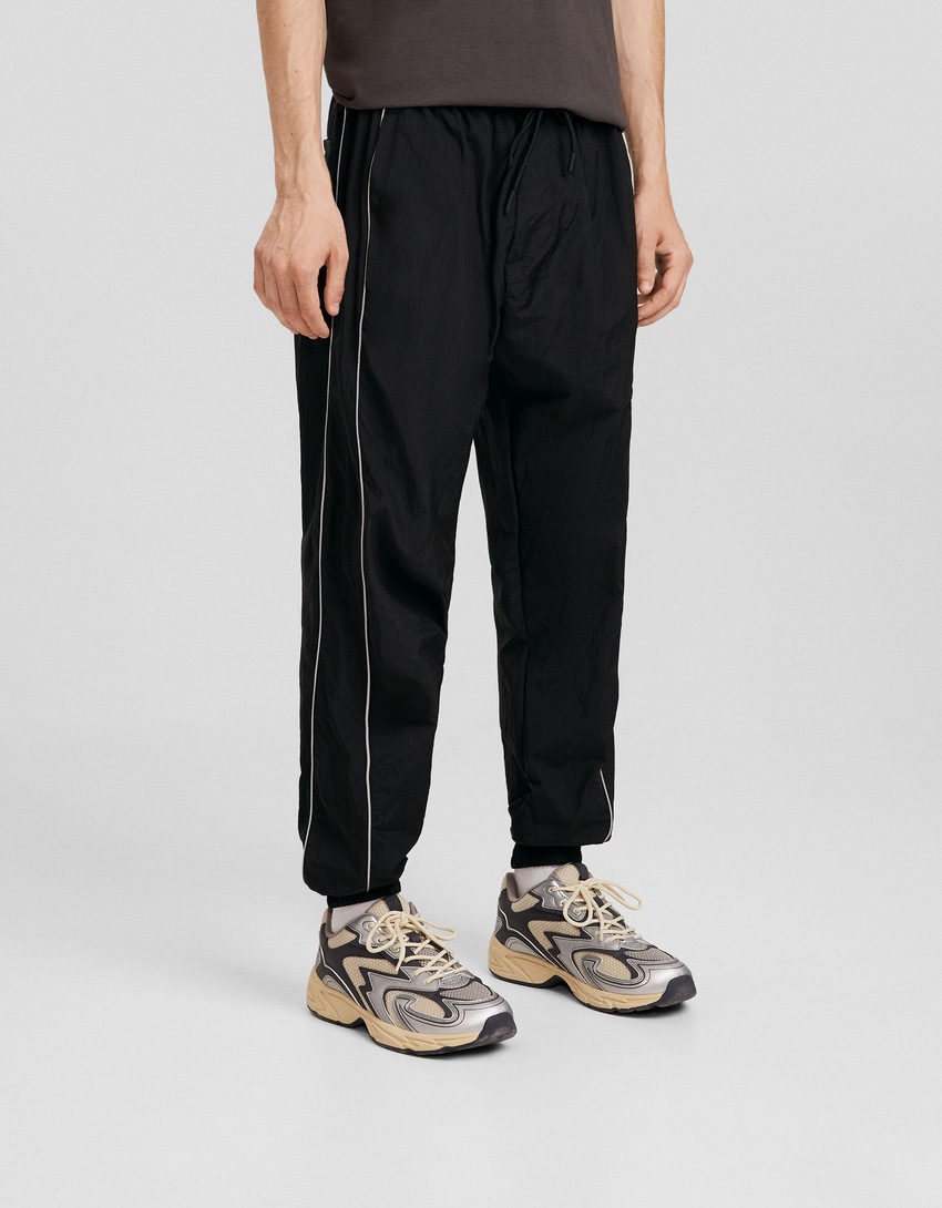 Calças de jogging técnicas com detalhes refletores