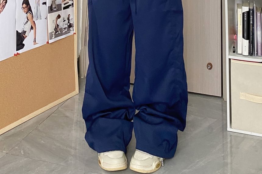 MELLO - Wijde broek met middelhoge taille en geruit paneel en letters